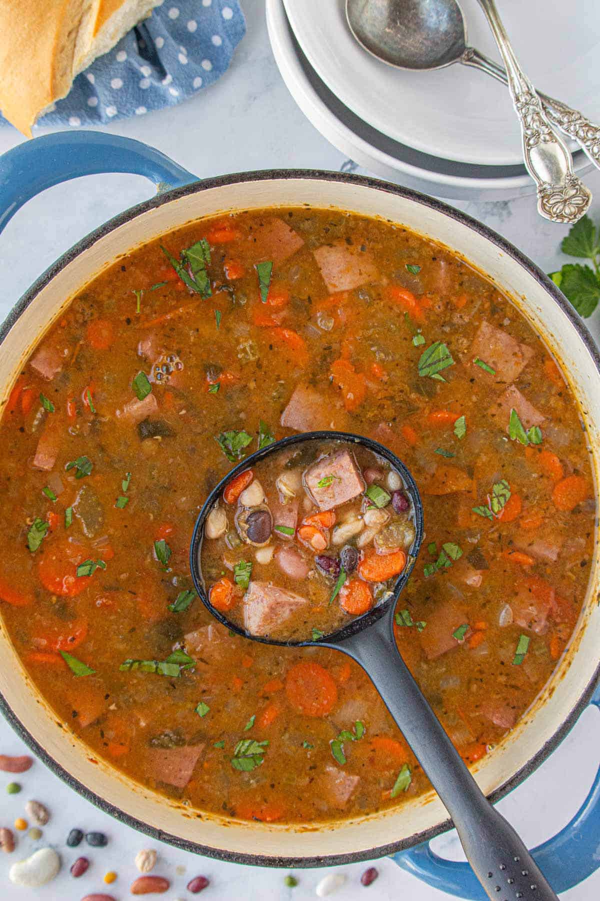 15 bean soup with ham in a stockpot with a ladle for dishing up the soup.