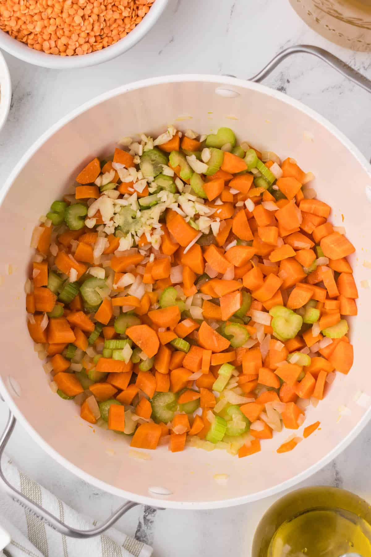 Carrots, onions, celery and garlic sautéing in a large soup pot.