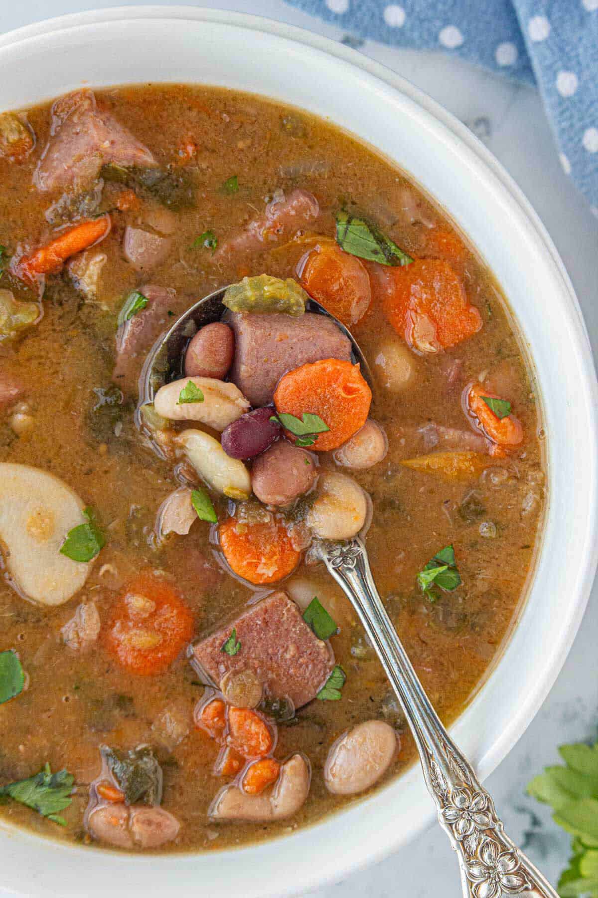 15 bean soup with a white bowl with a soup spoon.