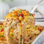 Cowgirl Casserole in a baking dish with a serving spoon taking a big scoop.