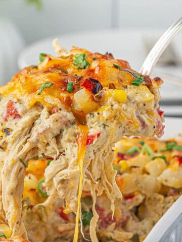 Cowgirl Casserole in a baking dish with a serving spoon taking a big scoop.