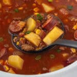 Cowboy stew in a crockpot with a ladle to dish up the soup.