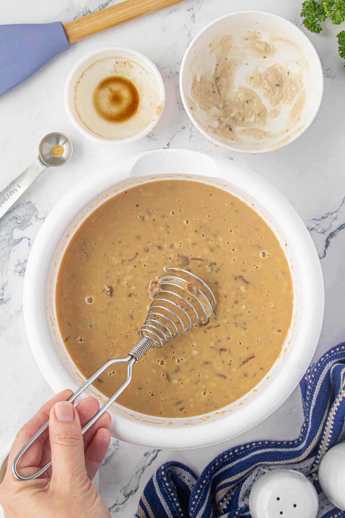 Creamy sauce being mixed together in a bowl.