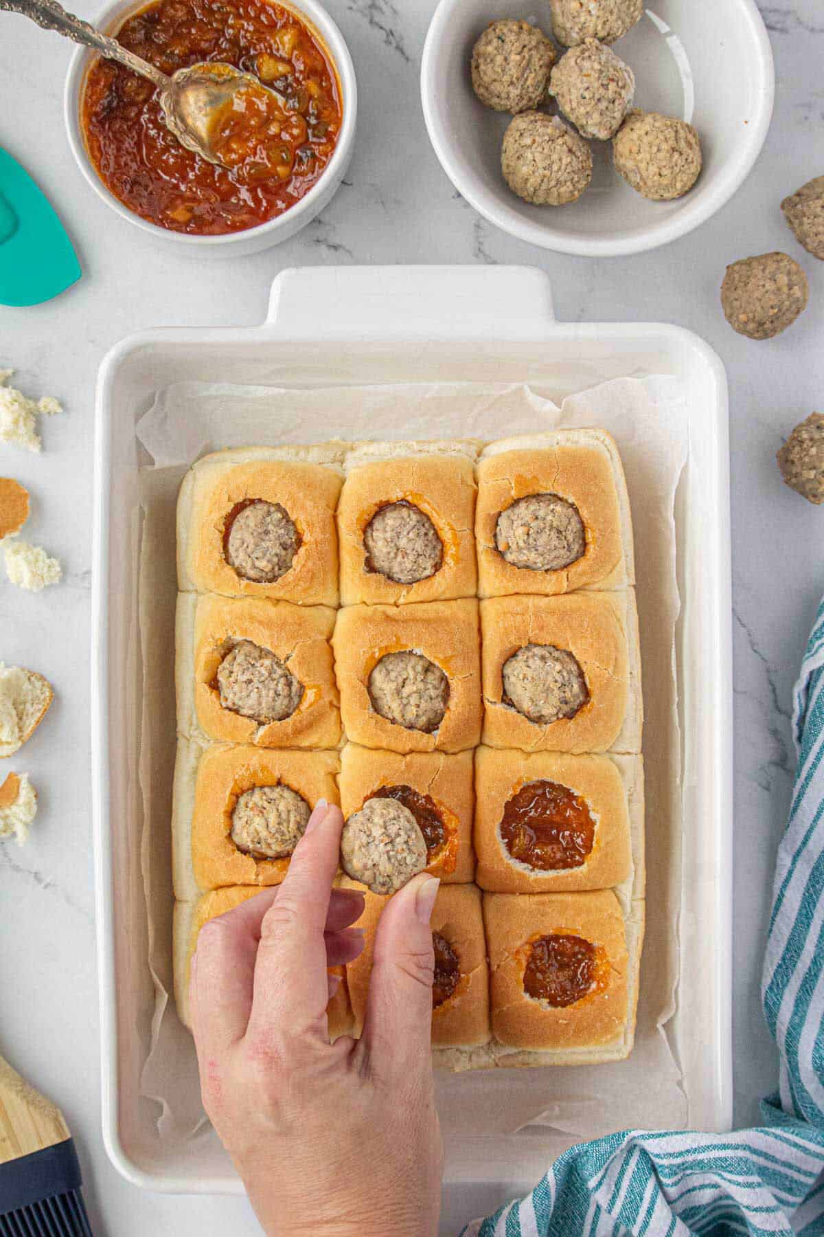 Meatballs placed into holes in the slider buns.