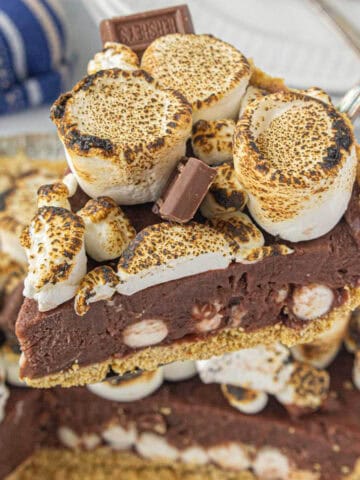 No bake s'mores pie sliced and held on a spatula.