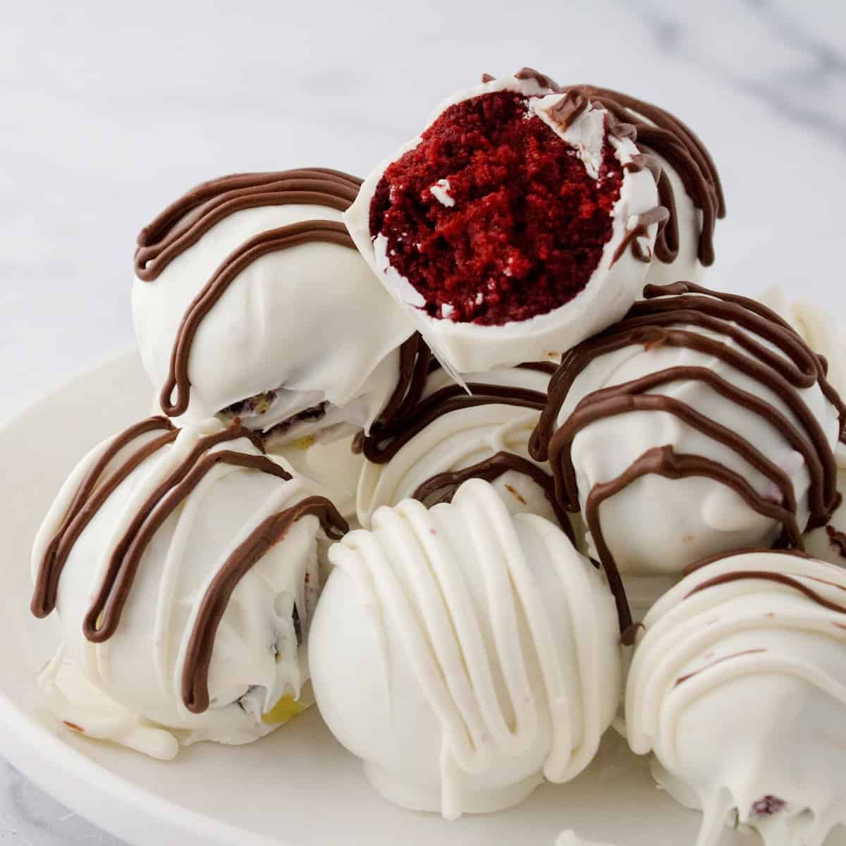 Chocolate covered Red Velvet Cake balls on a platter.