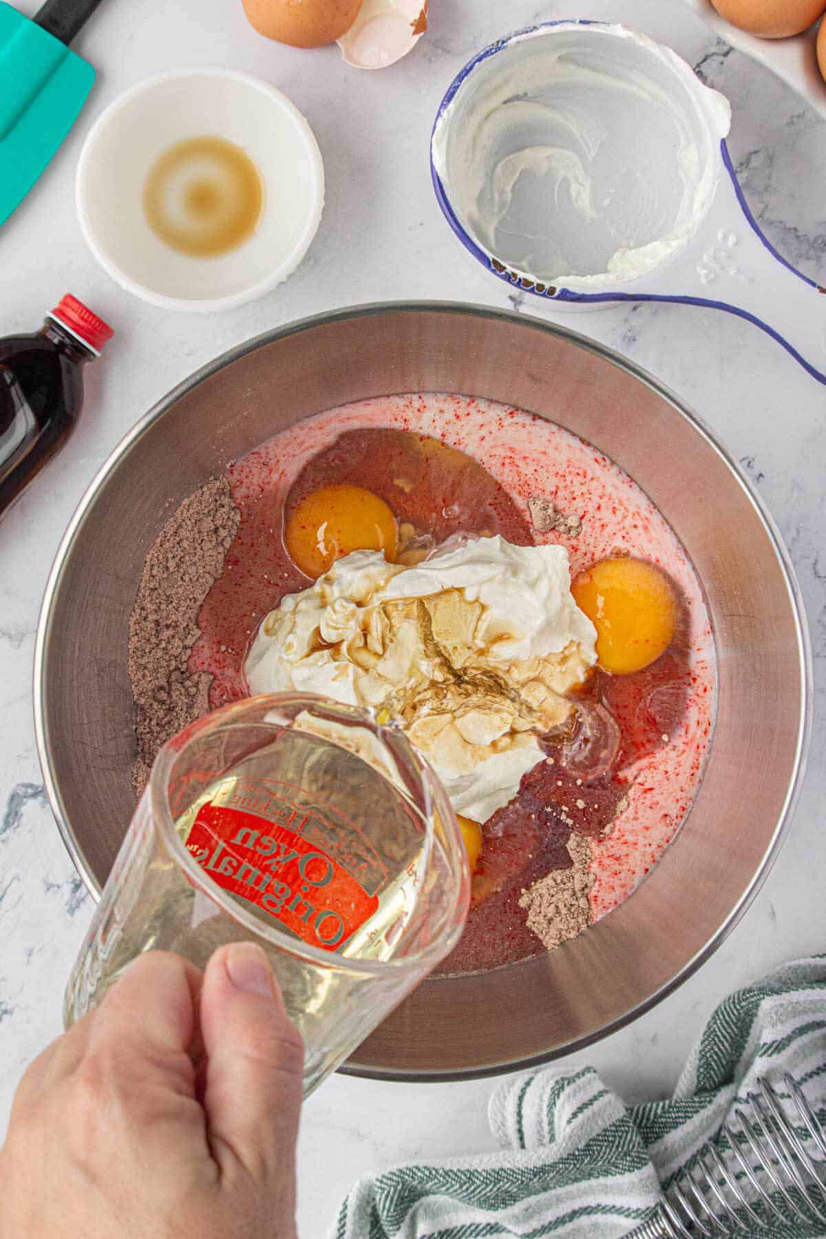 Cake mix in a mixing bowl. Combined with eggs, vanilla, sour cream, and oil.