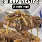 Smothered Steak on a plate topped with a rich brown onion and mushroom gravy. With print overlay for Pinterest.