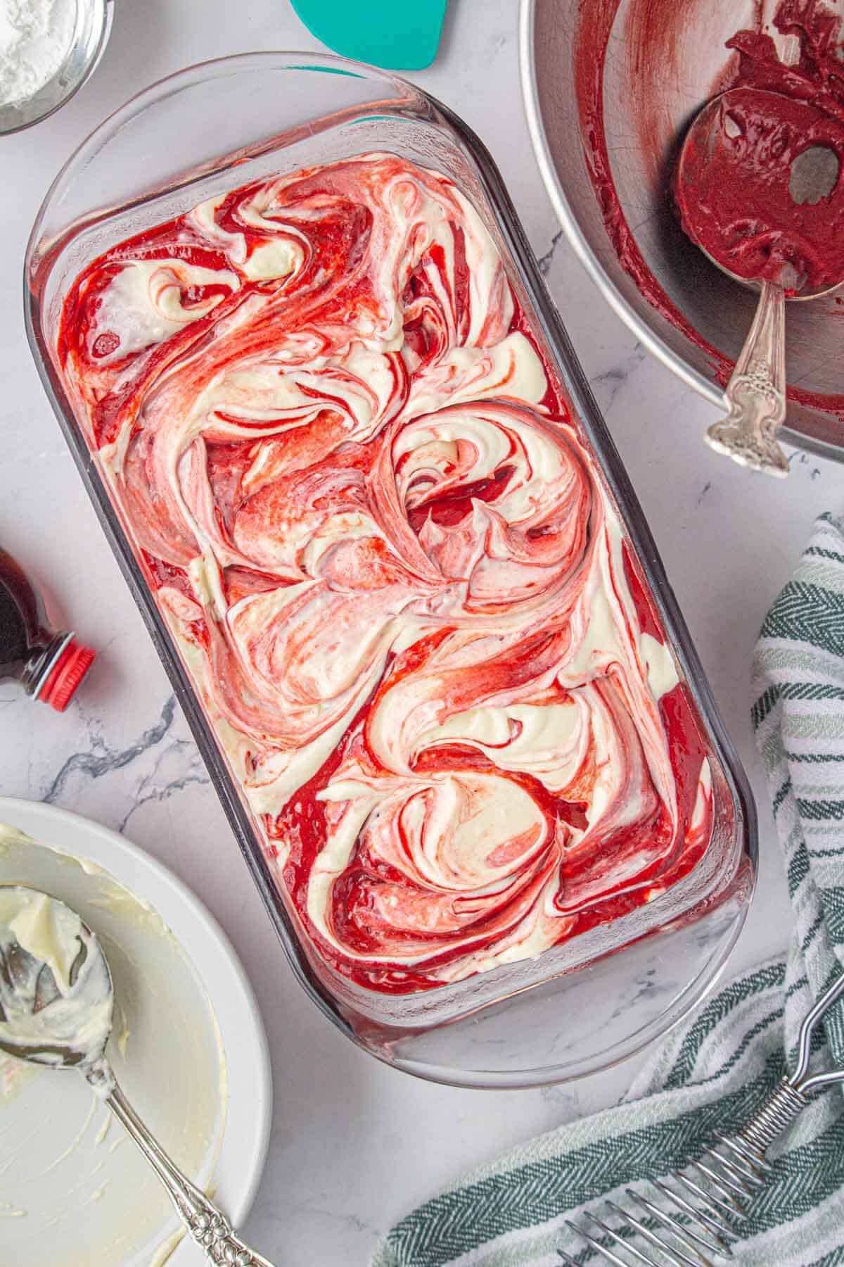 Swirled red velvet loaf in a baking dish.