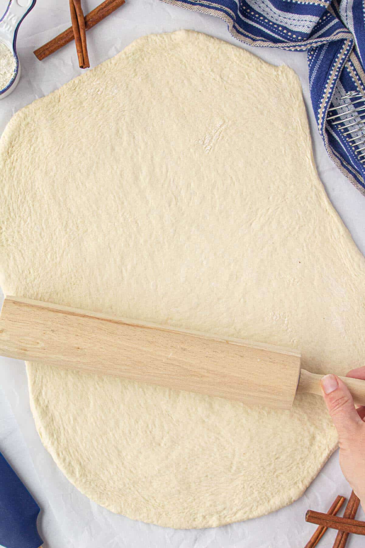 Bread dough rolled out into a rectangle with a roll pin.