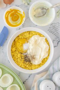 Crumbled egg yolks, mayo, salt, pepper and mustard in a small mixing bowl.