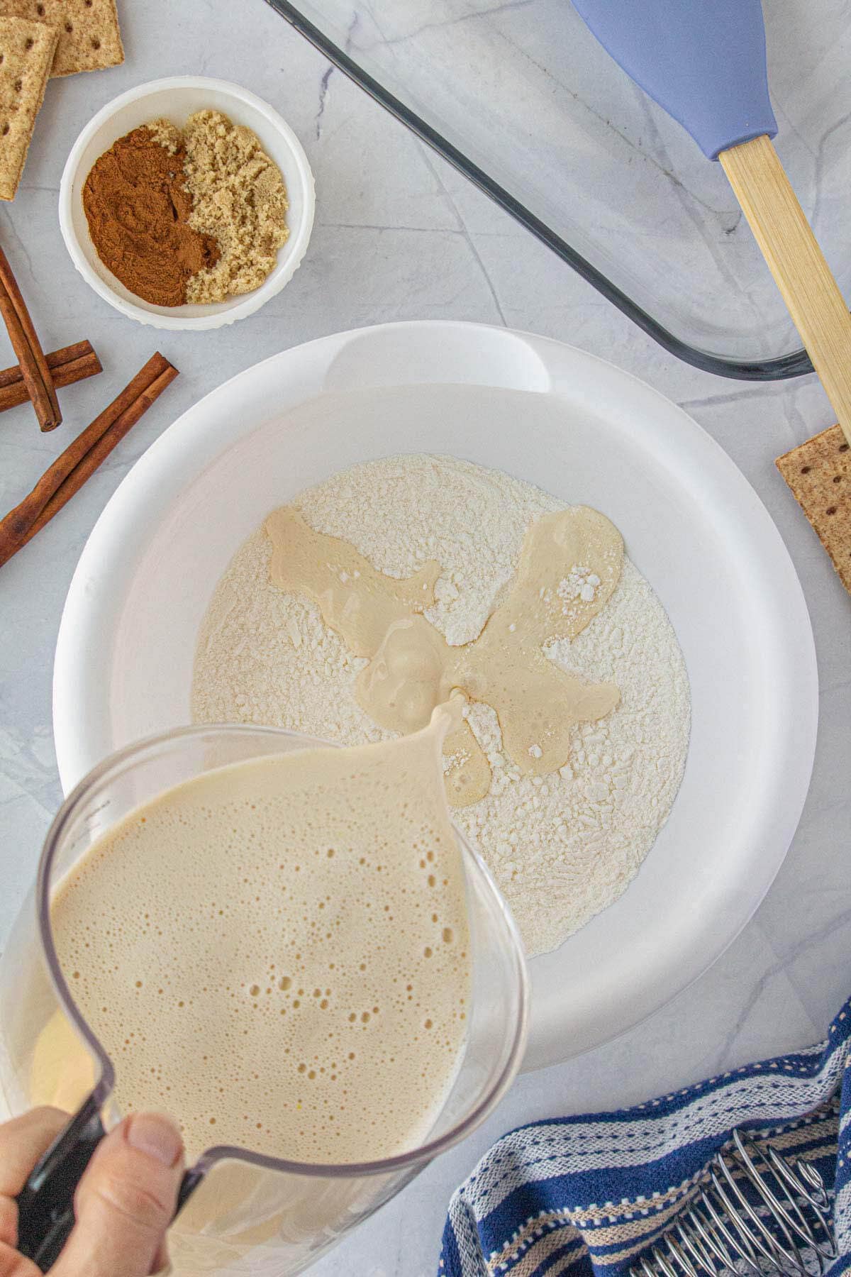 Instant pudding being mixed in a large mixing bowl.