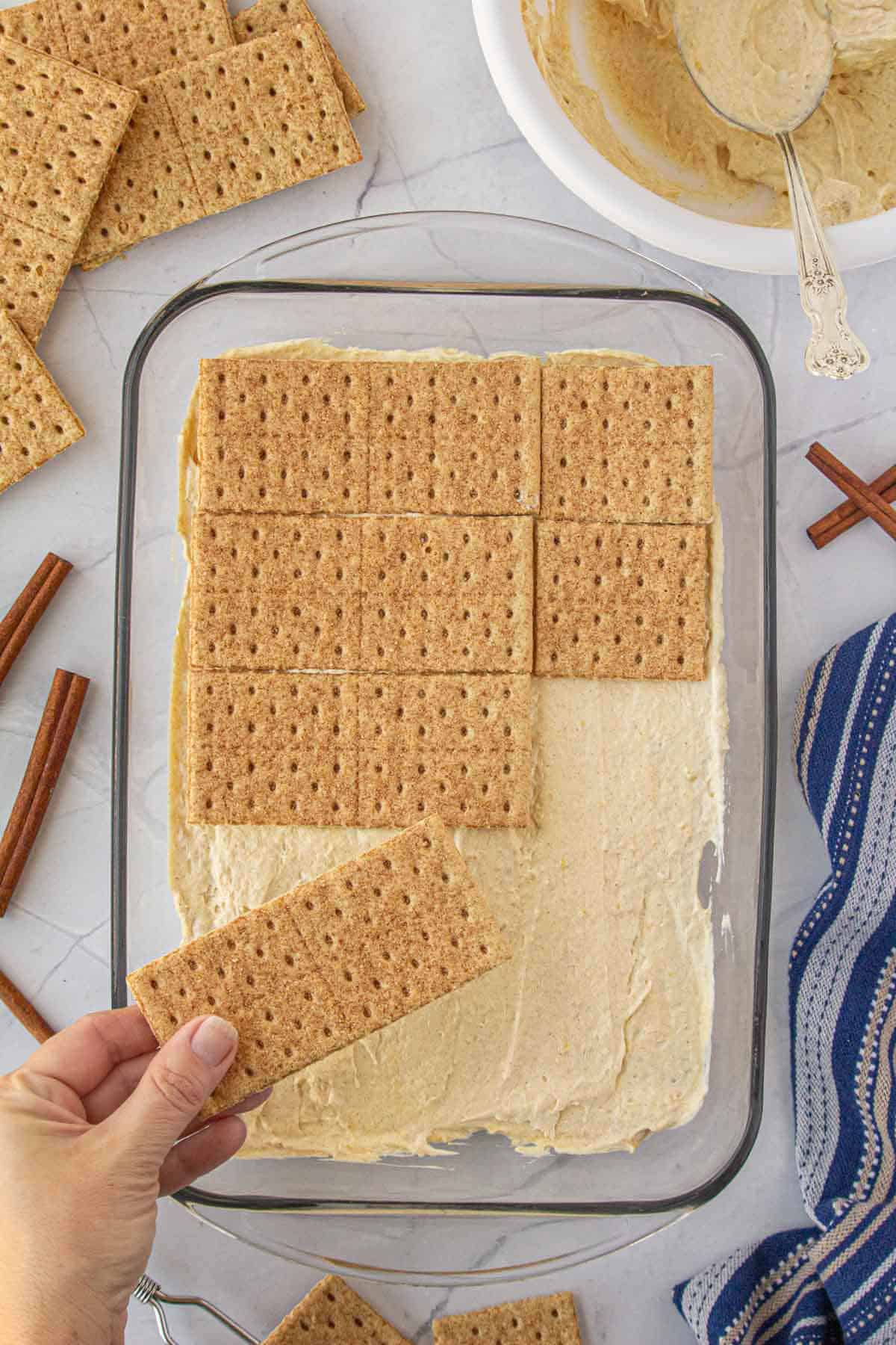 Cinnamon graham crackers placed over pudding to make the icebox cake.