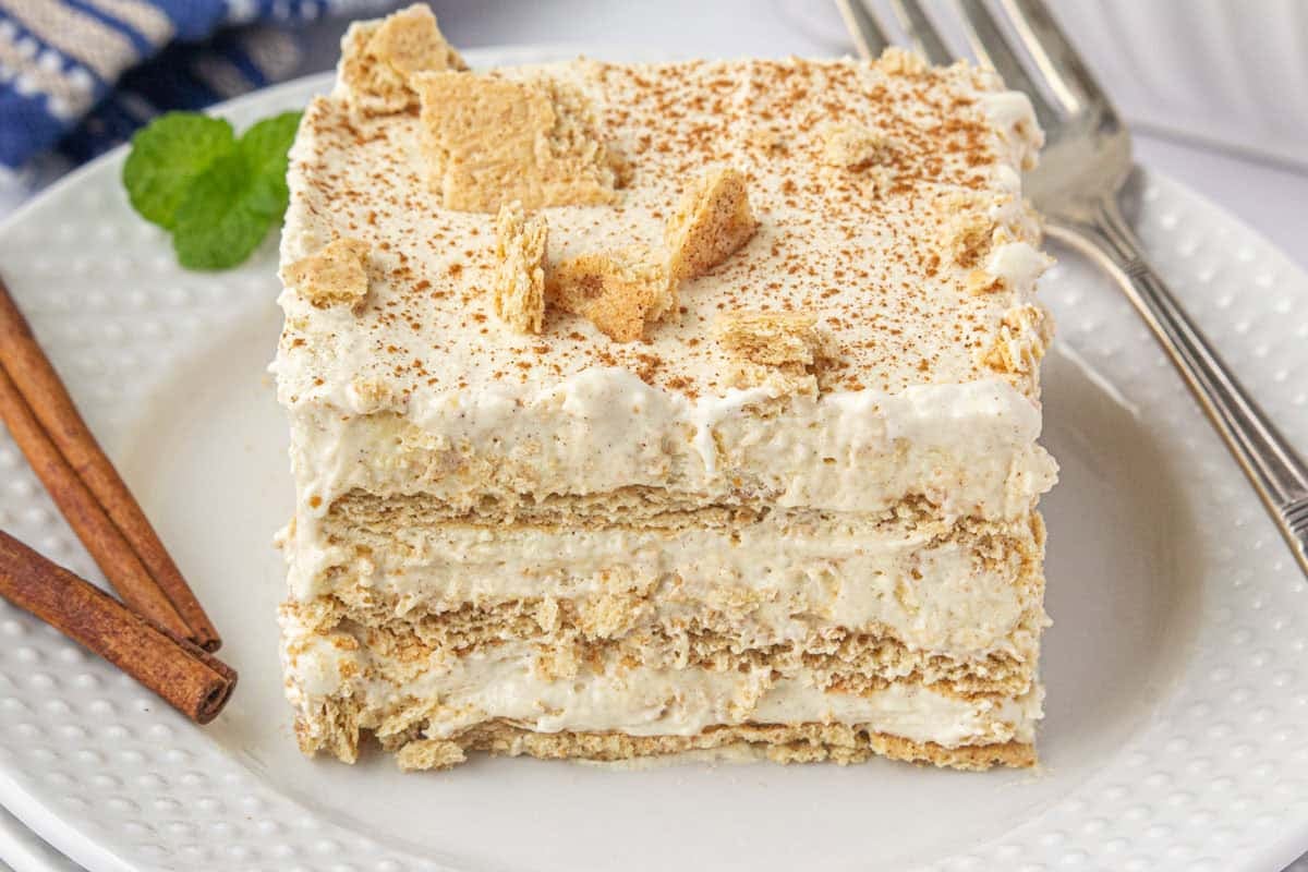 A slice of Snickerdoodle Graham Cracker Icebox Cake on a plate with a fork.