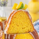 A slice of lemon bundt cake held on a spatula.