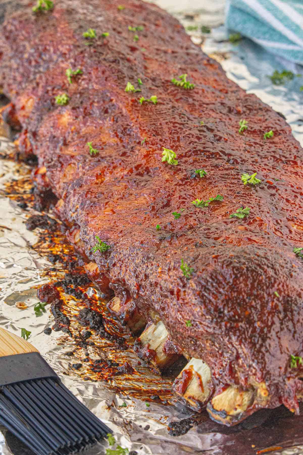 A slab of bbq pork ribs that have been slowly cooked in the oven.