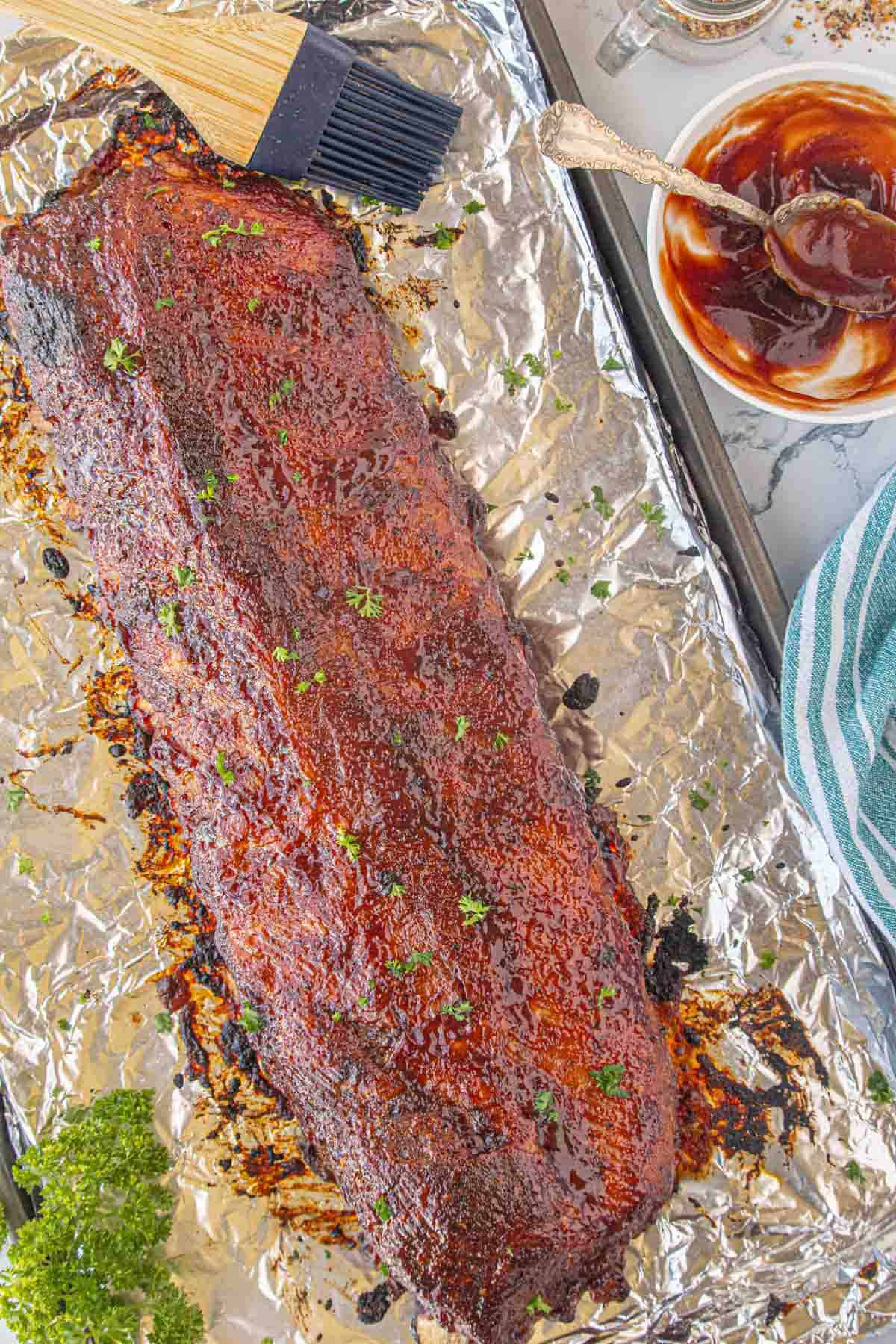 A rack of bbq pork ribs that have been finished under the broiler.