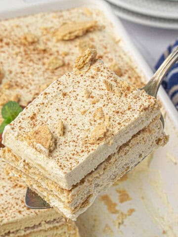 A slice of graham cracker icebox cake on a spatula.