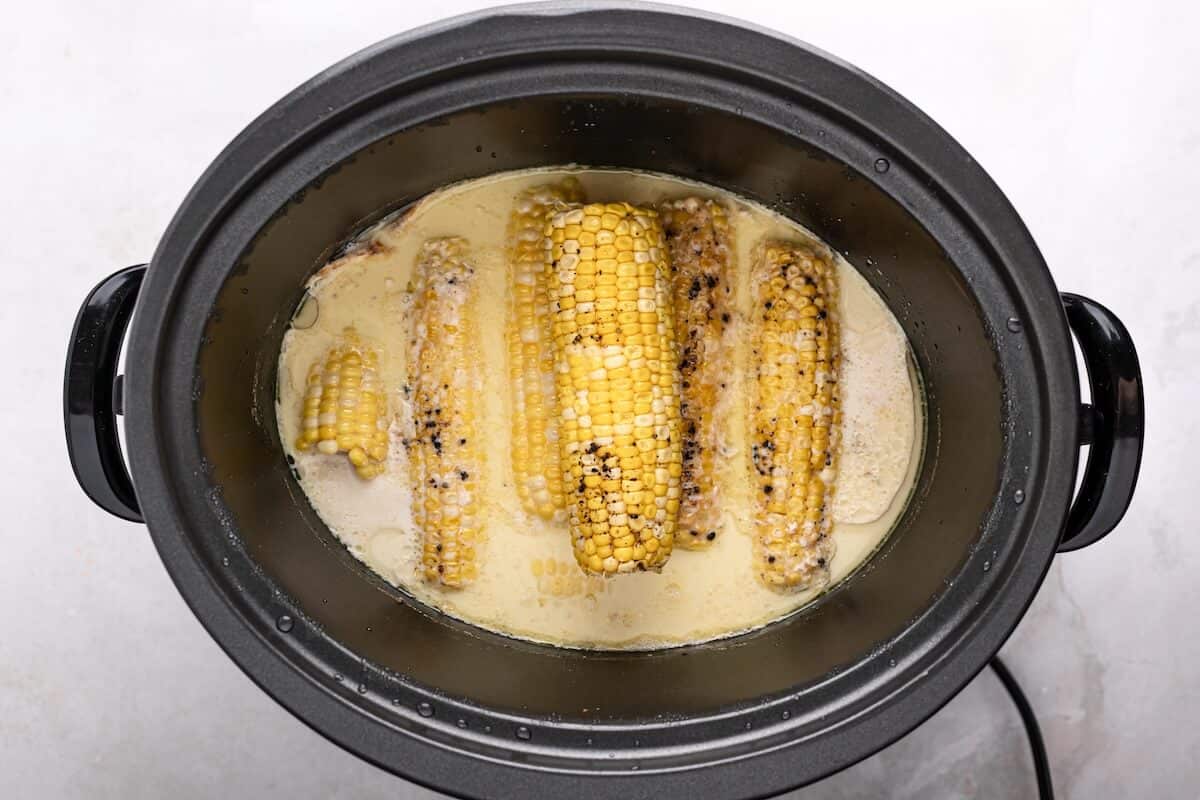 Corn simmered in butter and milk inside a slow cooker after cooking.