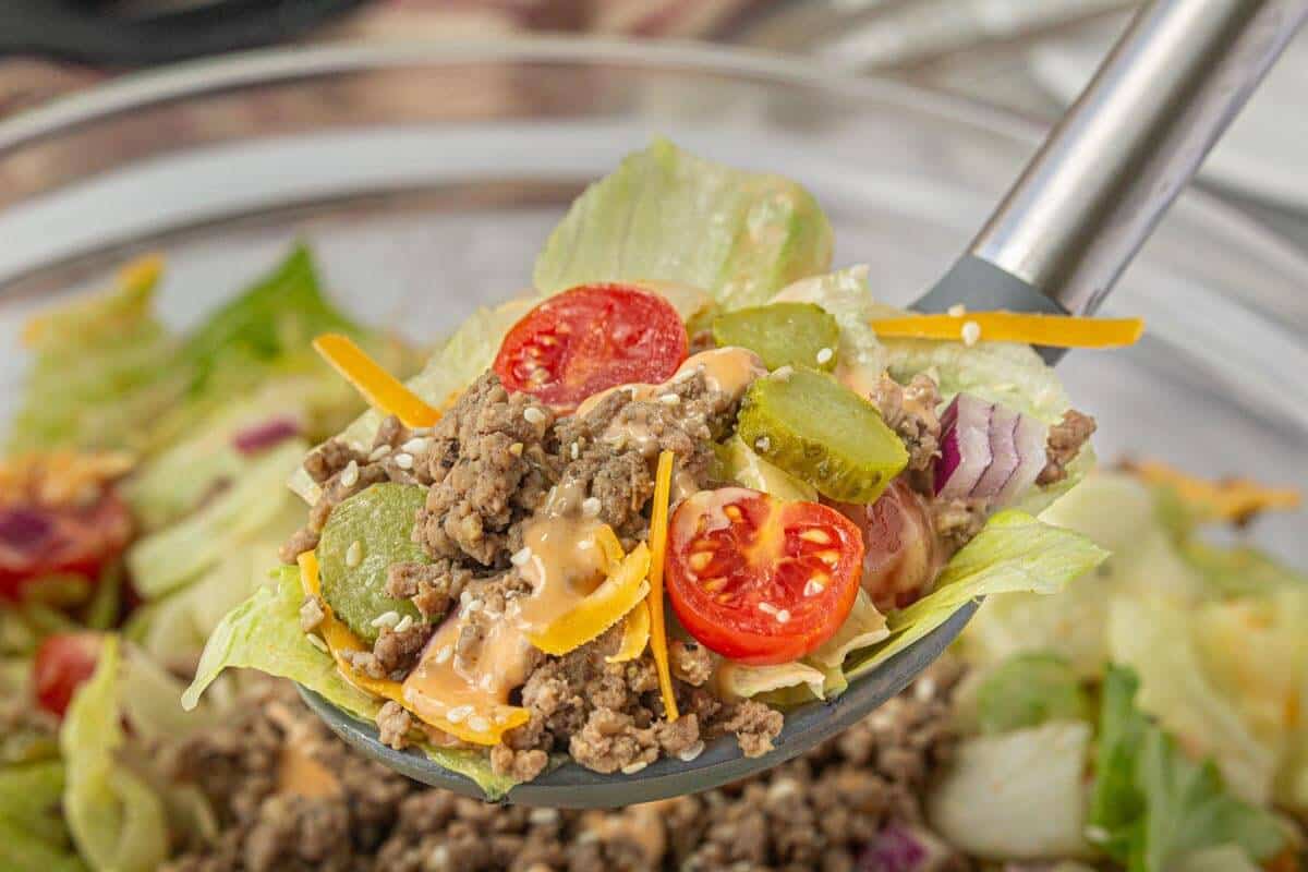 A scoop of lettuce salad in a large spoon.