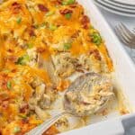 A look inside the casserole dish with one large serving scooped out, showing the creamy interior.