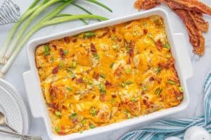Golden brown casserole fresh from the oven, with melted cheese and green onion garnish.
