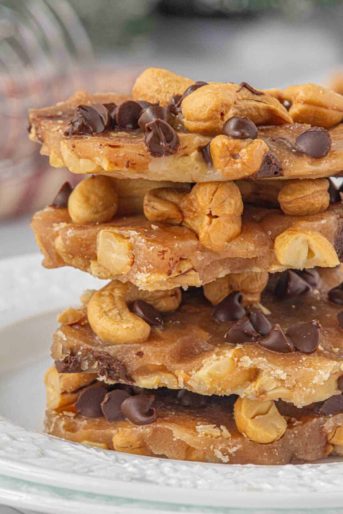 Four piece of toffee candy stacked on a white plate.