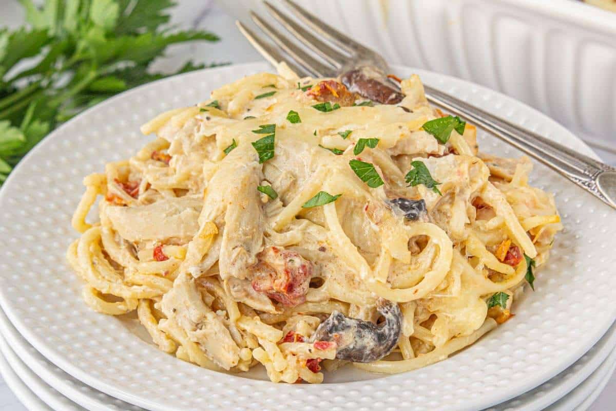 Chicken pasta bake on a plate with a fork on the side of the plate.