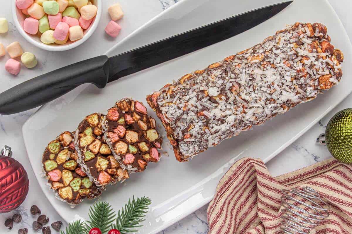 Slices of Cathedral Candy on a white platter, with the remaining unsliced log on the side.