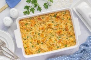 Baked chicken and rice casserole hot out of the oven, garnished with fresh parsley and ready to serve.