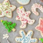 Decorated sugar cookies on a parchment lined baking sheet.