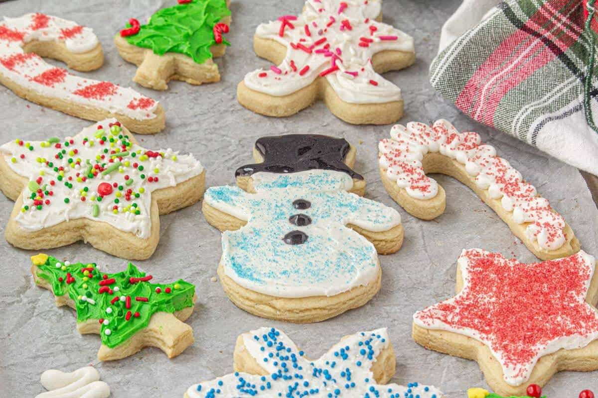 Decorated sugar cookies on a parchment lined baking sheet.
