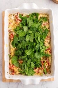 Fresh spinach added to baked orzo pasta before stirring into the melted Boursin sauce.