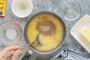 Active dry yeast sprinkled into warm milk and butter mixture to bloom before making bread.