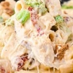 Creamy chicken and broccoli pasta with rigatoni, sun-dried tomatoes, and melted cheese, styled like Cheesecake Factory copycat recipe with text overlay.
