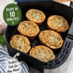 Six slices of crispy garlic bread toasted in an air fryer basket. With bold print overlay for Pinterest reading "Air Fryer Garlic Bread".