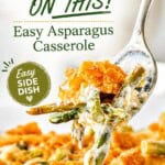 Fork lifting a bite of asparagus casserole with a creamy sauce and crispy Cheez-It topping from a baking dish. With print overlay for Pinterest.