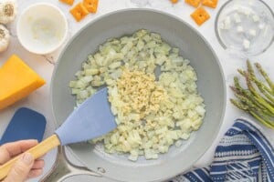 Diced onions and garlic saut&eacute;ing in butter in a skillet.