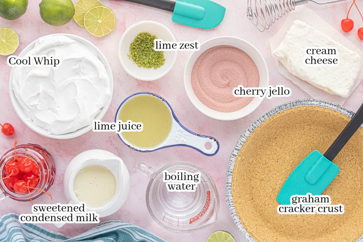 Ingredients for no bake pie including graham cracker crust, water, sweetened condensed milk, limes, Cool Whip, cream Cheese and cherry jello.