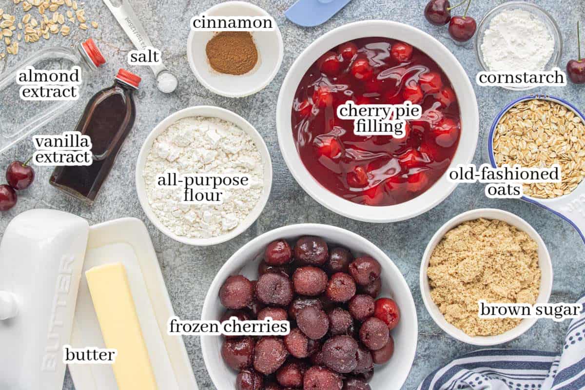 Ingredients for Easy Cherry Crisp Recipe, including frozen cherries, cherry pie filling, oats, flour, brown sugar, butter, vanilla, almond extract, cinnamon, salt, and cornstarch.