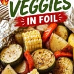 Pinterest pin featuring grilled potatoes and veggies in foil with bold text overlay reading "Grilled Potatoes and Veggies in Foil." The image shows grilled zucchini, red potatoes, sweet corn, and bell peppers cooked in a foil packet, making an easy summer side dish for cookouts, camping, and backyard BBQs.