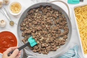 Ground beef and diced onions browning in a skillet.