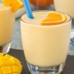 Close-up of a thick and creamy Mango Orange Creamsicle Smoothie garnished with a fresh orange slice.