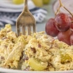Close-up of curry chicken salad made with shredded chicken, grapes, celery, red onion, and creamy curry dressing.
