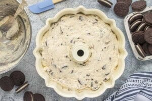 Oreo cookie cake batter spread evenly in a prepared Bundt pan.