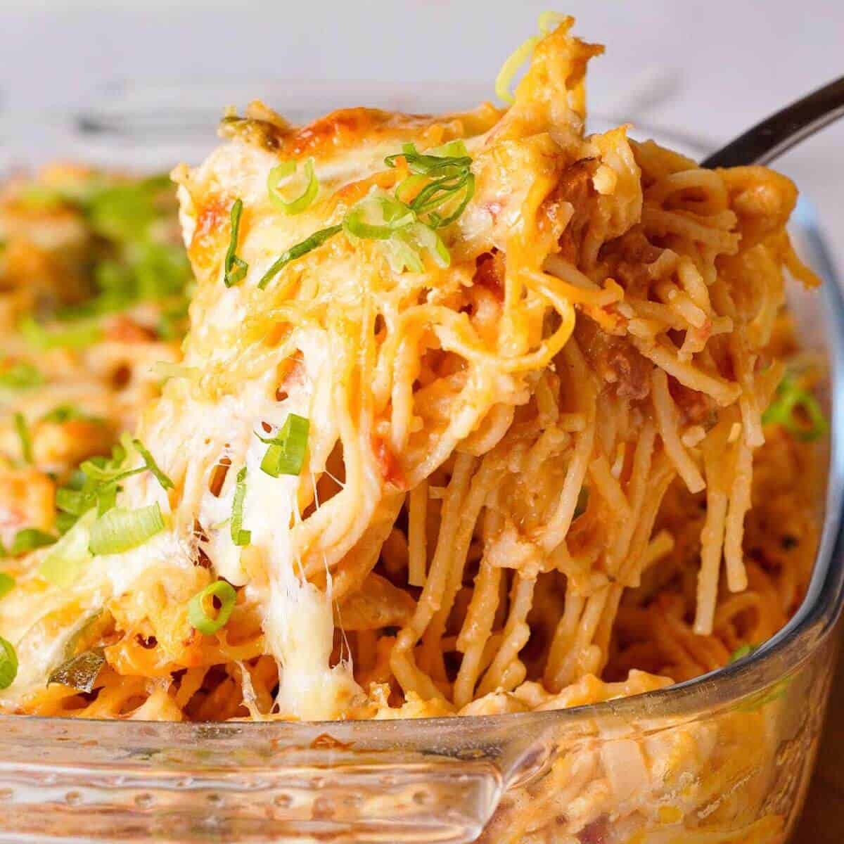 Cheesy crack chicken spaghetti casserole with tender chicken, bacon, melted cheese, and sliced green onions.