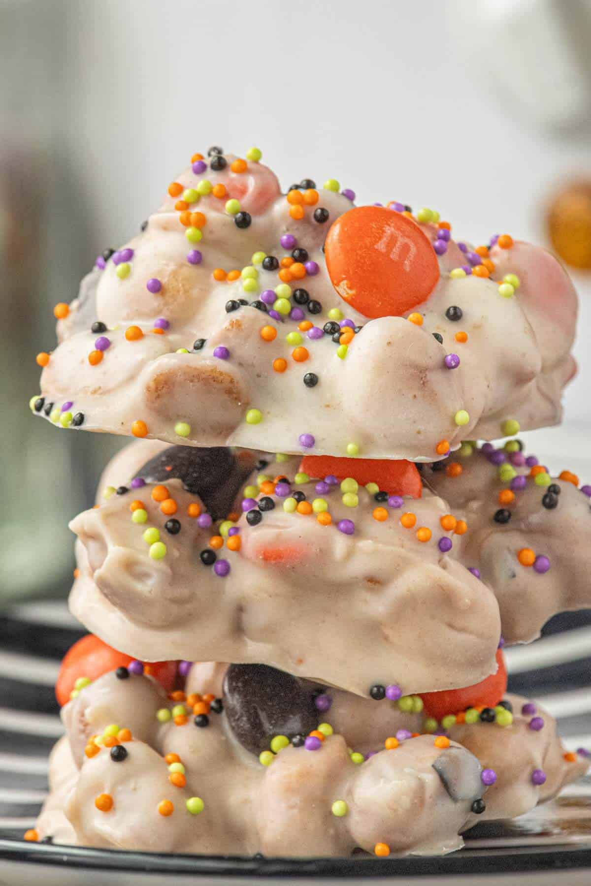 Stack of creepy crockpot candies topped with orange and black M&M’s and colorful Halloween sprinkles.