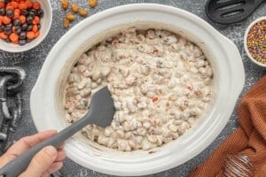 Melted vanilla almond bark stirred with peanuts and Halloween M&M's in the crockpot.