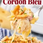 Crockpot Chicken Cordon Bleu casserole with creamy chicken, ham, noodles and melted cheese topped with buttery crackers, with a cheesy forkful lifted above the dish.