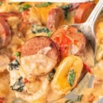 Pinterest pin featuring creamy Tuscan gnocchi with chicken sausage, spinach and sun-dried tomatoes in a skillet.